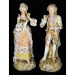 A pair of Austrian bisque porcelain figures, of a lady and gentleman, each dressed in finery, he