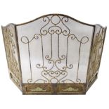 A wrought iron three part spark guard, decorated with scrolls, applied with leaf moulding,