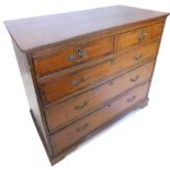 An early 19thC oak and mahogany crossbanded chest of drawers, with a moulded cornice, above two