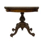 A Victorian figured walnut card table, with shaped fold-over top, having blind fret carved border,