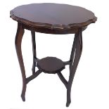 An Edwardian walnut occasional table, the circular top with a shaped moulded edge, on cabriole legs,