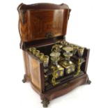 A 19thC French Kingwood and gilt metal liqueur set, the serpentine shaped box with a double hinged