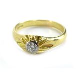 An 18ct gold diamond solitaire ring, the diamond in platinum rub over setting, with raised and waved