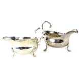 Two similar silver sauce boats, each with a wavy edge, scroll cast handle and three feet, 6½oz.