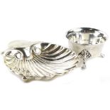 A Victorian silver shell shaped butter dish, London 1889, and a circular silver salt on three