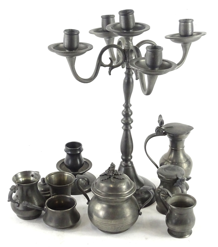 A Continental pewter four branch candelabra, and various pewter measures etc.