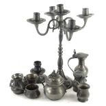 A Continental pewter four branch candelabra, and various pewter measures etc.
