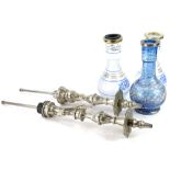 Three Middle Eastern glass hookah pipes, one blue, the others clear, but with blue stencil