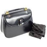 A vintage Gucci black leather top handle bag, with gold hardwear and dustbag.
