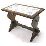An oak coffee table, the rectangular top inset with Delft style blue and white tiles, on end