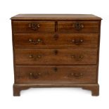 A George III oak chest, of two short and three long graduated drawers, with brass loop handles, oval