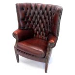 A mahogany and red leather button back porters chair, with brass studded decoration on square