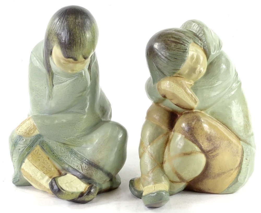 A pair of Lladro porcelain figures, each modelled in the form of an Eskimo or Inuit girl, 27cm H and