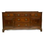 A late 18thC oak dresser base, with low level drawer frieze on a moulded top, with three frieze