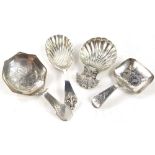 A collection of various silver caddy spoons, to include an example with a shell bowl and shell