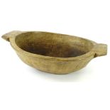 A late 18th/early 19thC French adzed two handled fruitwood bowl, (AF), 57cm W.