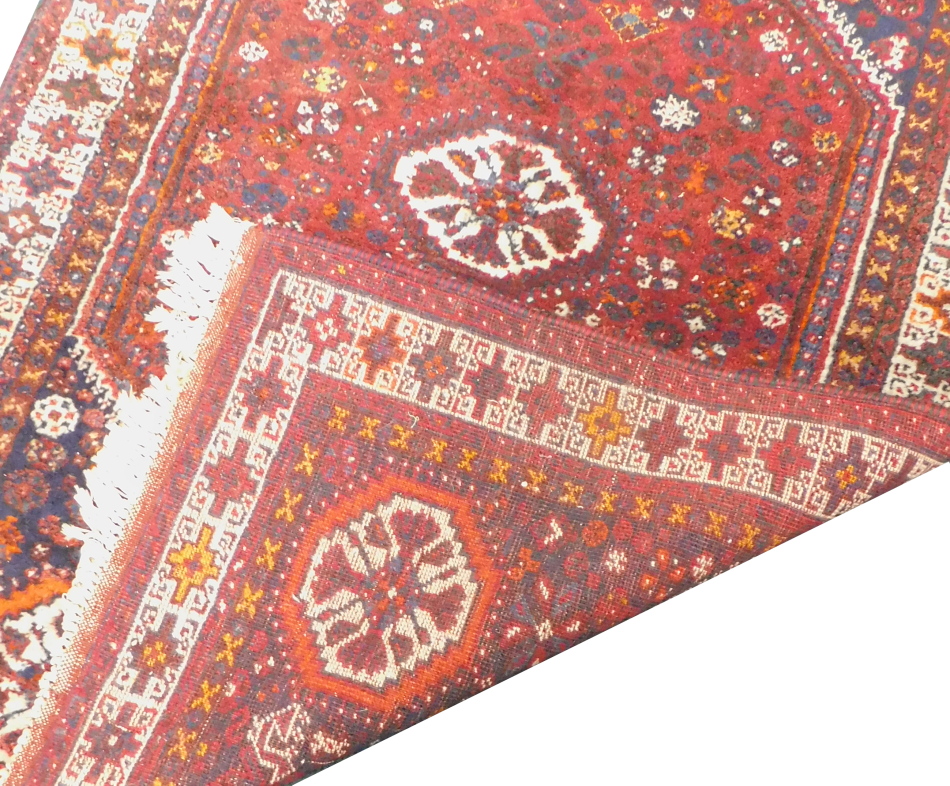 Two similar Turkish type small rugs or mats, each on an orange ground, 86cm x 65cm and 87cm x 63cm. - Image 2 of 3