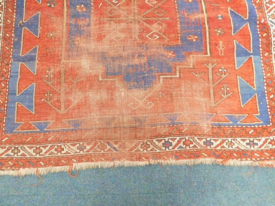 Withdrawn from sale - Retained by the Executors. A Turkish rug, with three medallions on a blue - Image 2 of 3