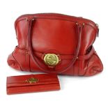 A Gucci Reins Boston handbag, in red leather with associated wallet.