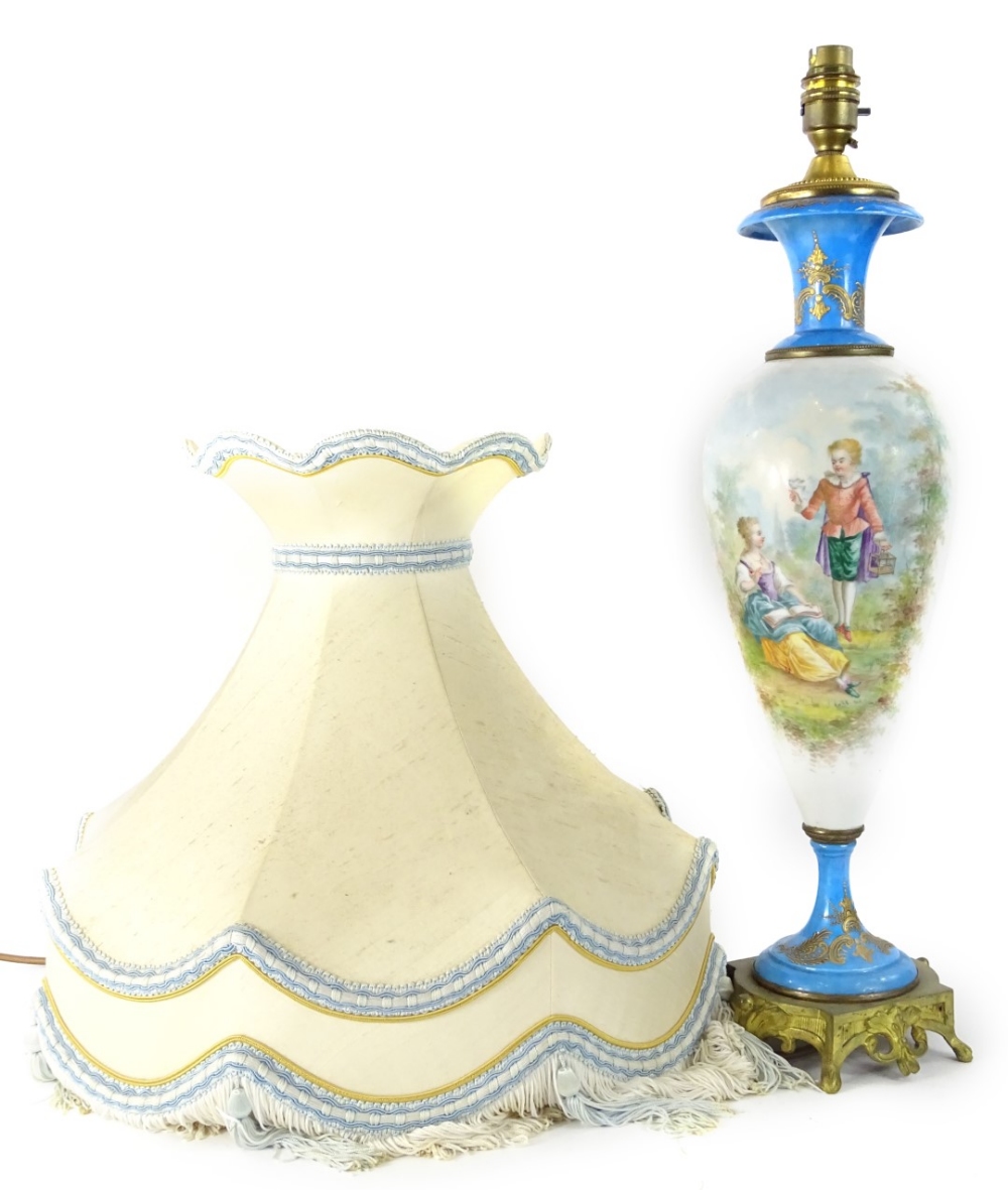 A late 19thC Sevres style porcelain lamp base, painted with French style figures, on a white ground,
