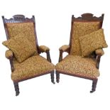 A pair of Victorian walnut salon type open armchairs, with a padded back, armrests and seat,