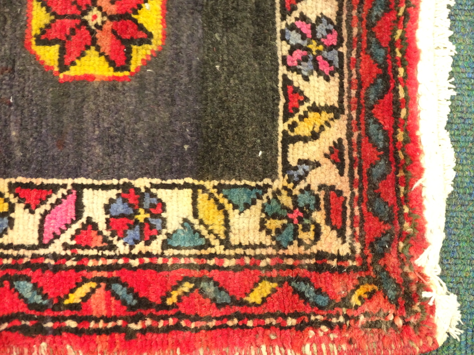 A Hamadan runner, with a central multi coloured pole medallion on a red and blue ground, with - Image 2 of 3