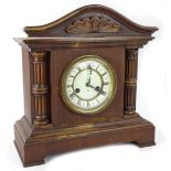 A late 19th/early 20thC Junghans German mantel clock, with an enamel dial, in an oak case, 38cm W.