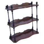 An ebonised and yew three tier wall shelf, with reeded decoration, 49cm W.