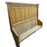 A late 19th/early 20thC ecclesiastical pew or settle, the raised back carved with lozenges,