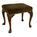 A Georgian style walnut stool, with green velvet seat and raised on four stylised carved cabriole