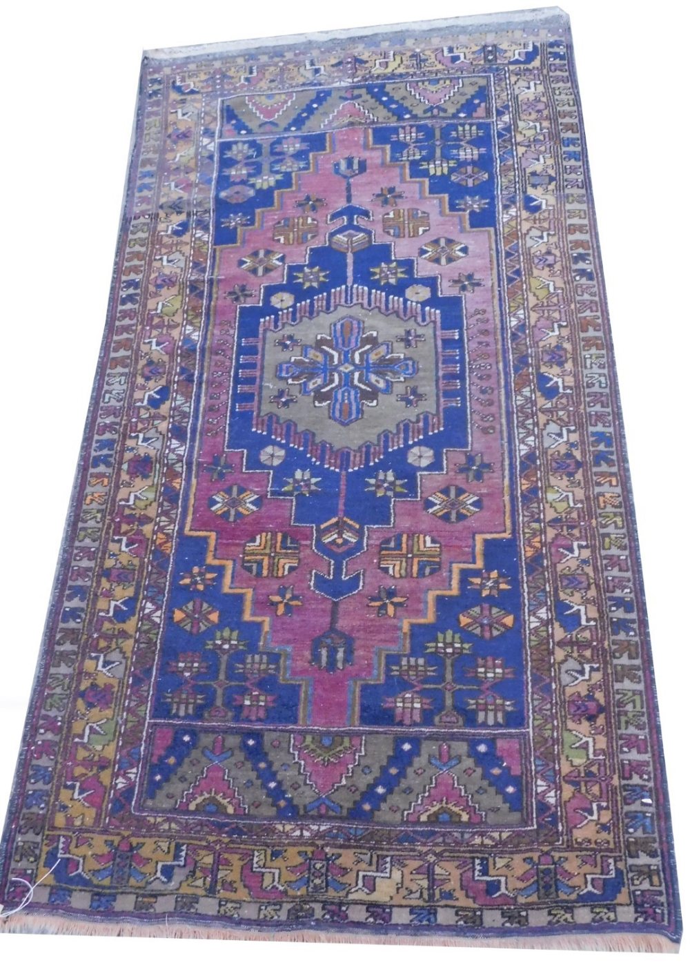 A Persian type rug, with a central pole medallion, on a maroon ground with blue spandrels, one