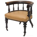 A Victorian walnut tub shaped library chair, with spindle turned supports, upholstered in beige