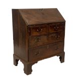 A George II walnut bureau, with flame veneered fall flap resting on lopers, revealing a fitted