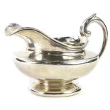 A William IV plain silver milk jug, with shaped handle and domed foot, London 1834, 7¾oz