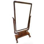 A Victorian figured mahogany cheval mirror, the rectangular plate with rounded corners, on a 'U'