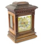 A late 19th/early 20thC German walnut cased mantel clock, the square dial with gilt spandrels and