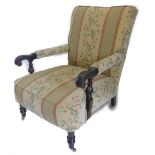 An early 20thC mahogany open armchair, with a padded back, armrests and seat, the scroll carved arms