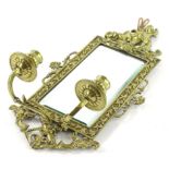 A Continental cast brass girandole wall mirror sconce, the elaborate frame decorated with putti,