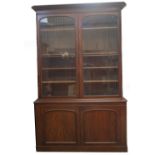 A Victorian mahogany cabinet bookcase, with moulded overhang cornice over two arch moulded and