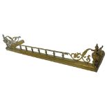 A late 19th/early 20thC brass fire kerb, with pierced decorations, turned rails etc., 148cm W.