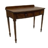 A William IV mahogany side table, with triple reeded bowfront top, two flame drawers with knob