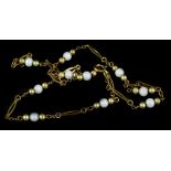 An Edwardian style costume jewellery necklace, with white and gold beads, and elongated links,