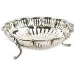 A George V silver bon bon dish, with a lobbed edge, pierced sides on scroll feet, Birmingham 1920,