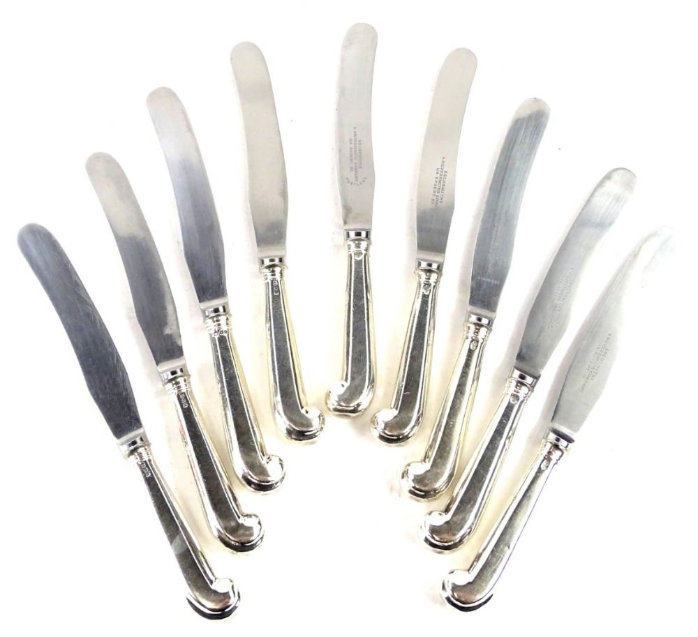 A set of nine Victorian silver pistol handled table knives, the stainless blades engraved Goldsmiths
