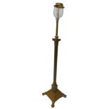 An early 20thC Corinthian column standard lamp, later painted in gold, on ball and claw feet,
