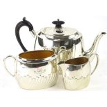 A Victorian silver three piece tea set, with part fluted decoration, ebonised knop and handle,