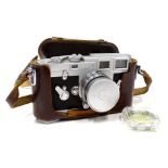 A vintage Leica Ernst Leitz camera, M3-857092, in brown leather case with Summicron f=5cm1:2 lens,