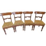 A set of four William IV mahogany dining chairs, each with a bar back, a padded seat, on turned