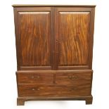 A George III mahogany linen press, with moulded top over two fielded panelled doors, with