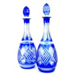 A pair of blue flash decanters and stoppers, with part hob nail cut decoration, 65cm H.